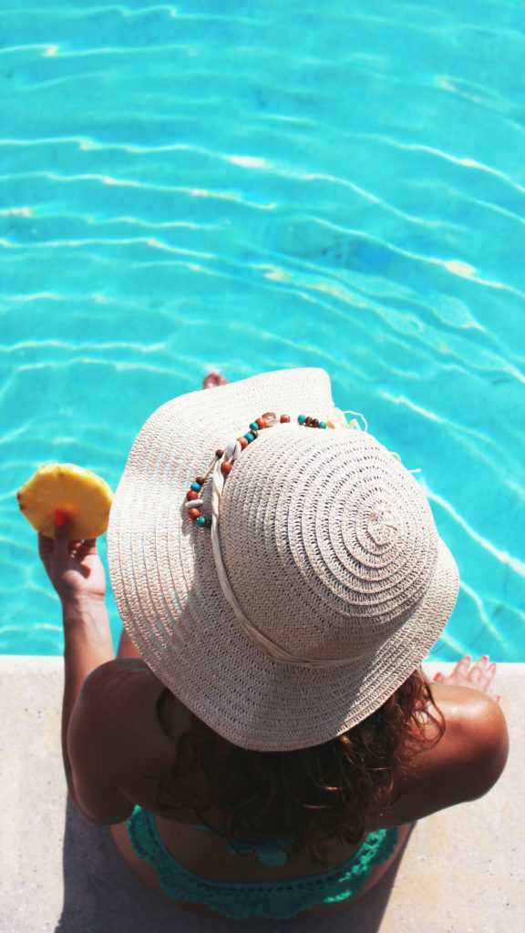 Femme mangeant un ananas au bord de la piscine - Maison de caractère en Dordogne - Maison Borreze